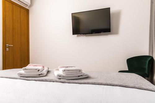 a room with a bed with towels on it at Olive Tree mansion in Vir