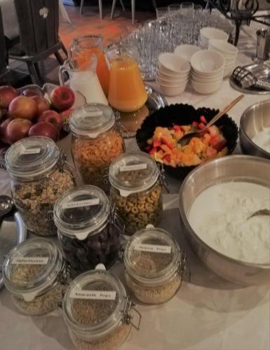 a table with jars of food and other foods at Haus Caspari in Altenahr