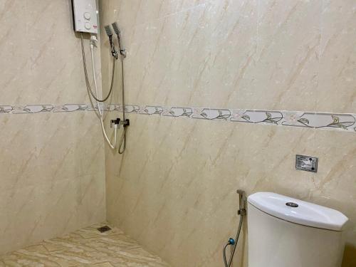 a shower in a bathroom with a toilet at Mariana Maldives in Gaafaru