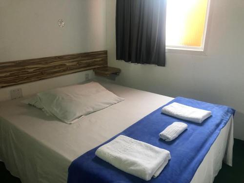 Un pat sau paturi într-o cameră la Villa Solarium Pousada