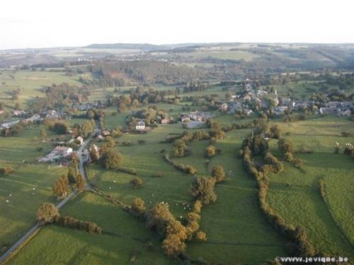 an aerial view of a field with houses and trees at O Près de la Lienne, maison de campagne de charme, accord parfait entre confort et authenticité in Lierneux