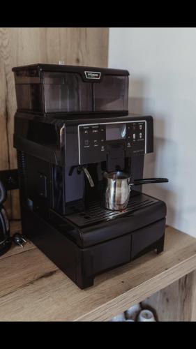 a black microwave with a pot on top of it at Ubytování Zahrada in Mutěnice