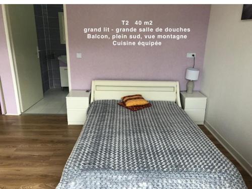 a bed in a room with a sign on the wall at Domaine des Anges in Amélie-les-Bains-Palalda