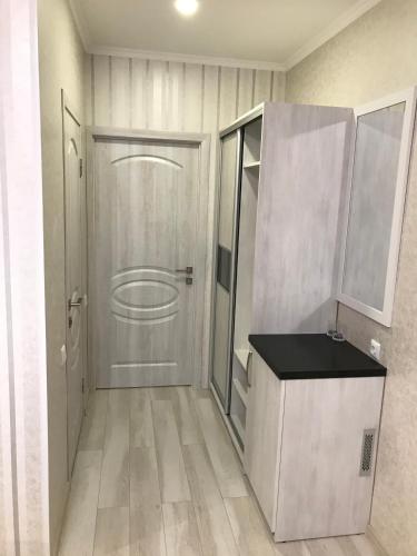 a bathroom with a white door and a counter at Holiday house in Vinnytsya