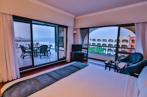 a bedroom with a bed and a large window at Basma Hotel Aswan in Aswan