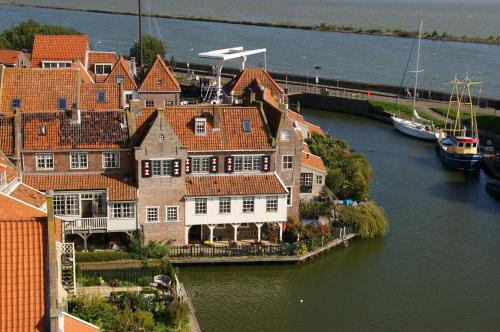 a group of houses by the water with boats at Holiday apartment with free parking Boven Jan Enkhuizen in Enkhuizen