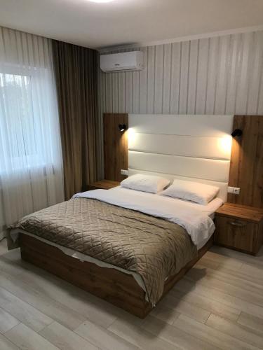 a bedroom with a large bed in a room at Holiday house in Vinnytsya