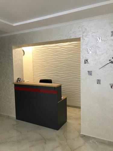 a reception desk in a room with a wall at Holiday house in Vinnytsya