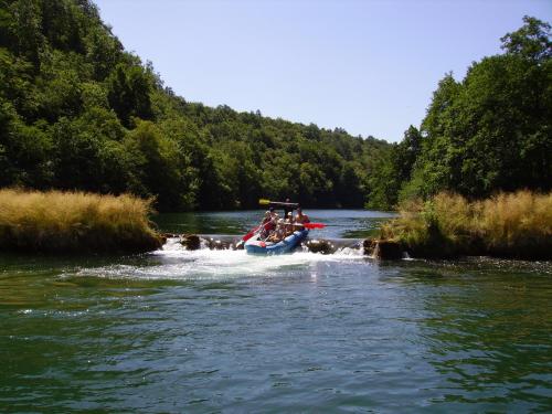a group of people in a boat on a river at Mrežnički kutak in Duga Resa