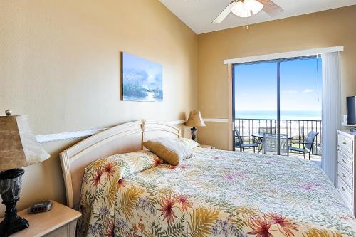 a bedroom with a bed and a view of the ocean at Phoenix 5 Unit 116 in Orange Beach