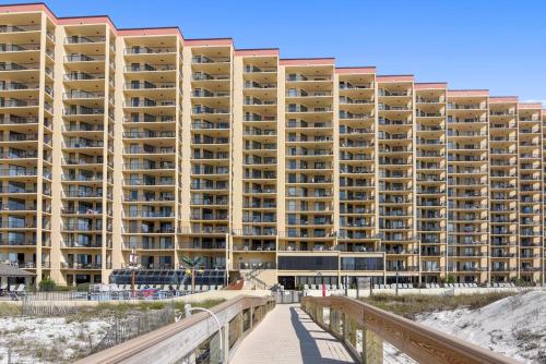 a large apartment building on the beach with a boardwalk at Phoenix 5 Unit 116 in Orange Beach