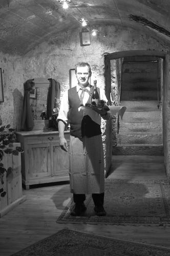 a man in a kilt holding a plate of food at Hotel Al Forte in Arabba