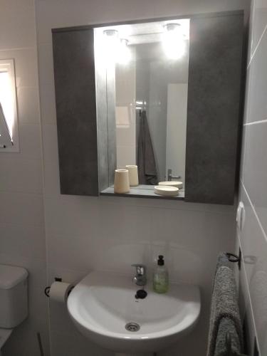 a bathroom with a sink and a mirror at Castillo Mar 87 in Caleta De Fuste