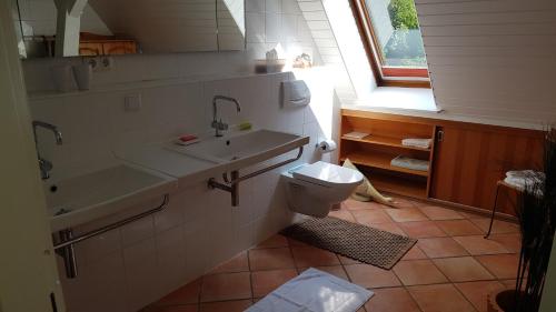 a bathroom with a sink and a toilet and a window at Lieblingsplatz in Bremen
