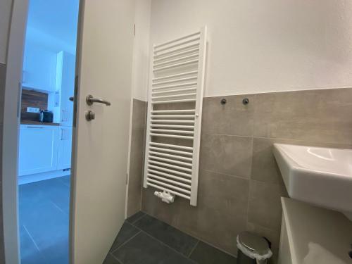 a bathroom with a toilet and a sink at VitAllgäu-Neues Studio mit Königscard in Pfronten