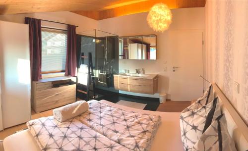 a living room with a bed and a sink at "sunnseit" Appartement in Söll