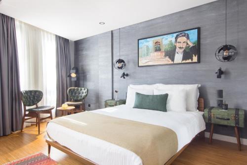 a hotel room with a bed and a painting on the wall at Hotel Poem in Istanbul