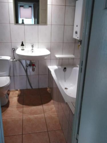 a bathroom with a sink and a toilet at Romera in Częstochowa