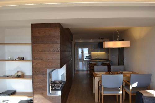 a living room and dining room with a table and a television at Luxury Wellness Apartment in Rokytnice nad Jizerou