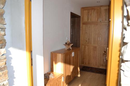 a hallway with a door and a wooden cabinet at Luxury Wellness Apartment in Rokytnice nad Jizerou