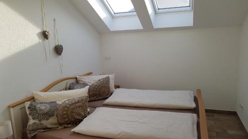 two beds in a room with a skylight at Holiday Home IIa in Süßen