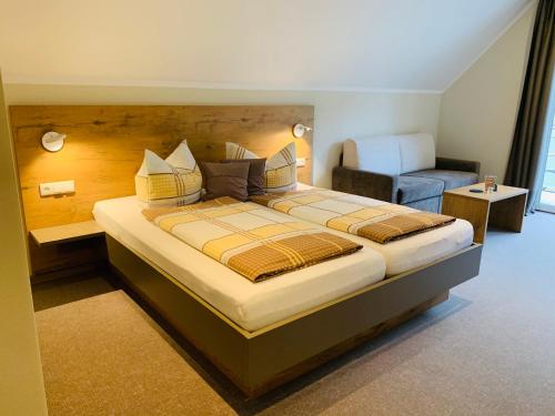 a bedroom with a large bed and a couch at Weinbergs Loge in Ernst