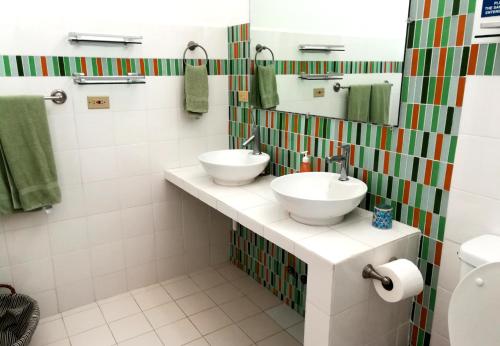 a bathroom with two sinks and a mirror at Togo B&B Farallon in Playa Blanca
