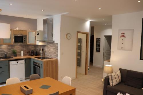 une cuisine et un salon avec un canapé et une table dans l'établissement Le cosy de L'évéche, à Marseille