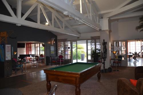 a pool table in the middle of a room at Hotel et Spa Les Cleunes Oléron in Saint-Trojan-les-Bains