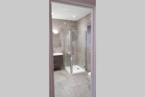 a bathroom with a shower and a sink at Kiln Cottage in Fareham