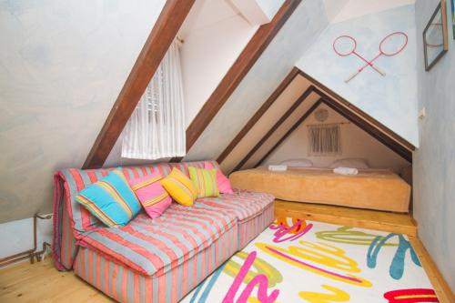 a living room with a couch and a bed at Holiday House Pure Nature in Lučica