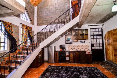 a room with a staircase and a stair case at Runda Lofts in Nairobi