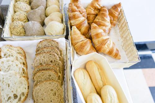 a bunch of different types of bread and pastries at Sintra Boutique Hotel in Sintra