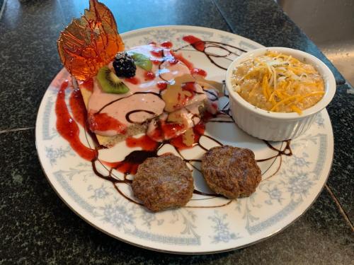 a plate of food with meatballs and a salad at Peace & Plenty Inn Bed and Breakfast Downtown St Augustine-Adults Only in Saint Augustine