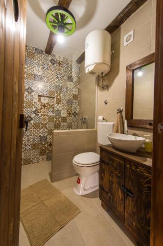 a bathroom with a toilet and a sink and a mirror at Kuća za odmor Atar in Bartolovci