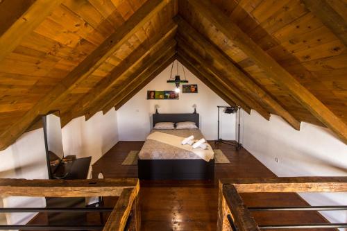 a bedroom with a bed in a attic at Kuća za odmor Atar in Bartolovci