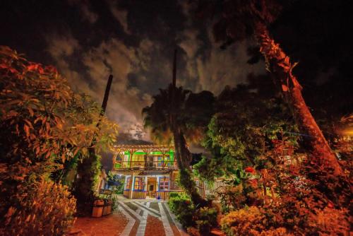 a painting of a house at night with flames at Eco Hotel las Palmas in Armenia
