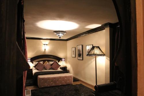 a bedroom with a bed and a lamp at Riad Terra Bahia in Marrakech