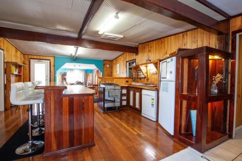 a kitchen with wooden floors and a white refrigerator at Rustic Retreat Esperance in Esperance