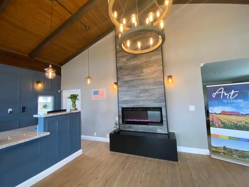 a lobby with a fireplace and a chandelier at Inn at Highway 1 in Lompoc