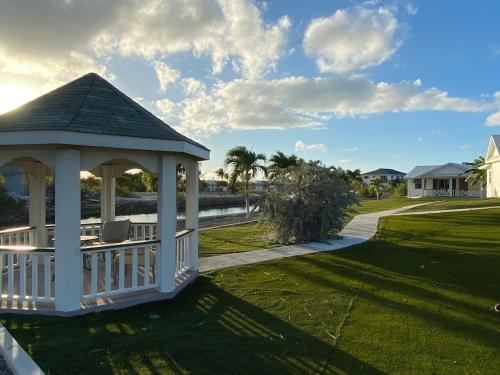 a gazebo on the lawn of a house at Palm Point Loft in Turtle Cove