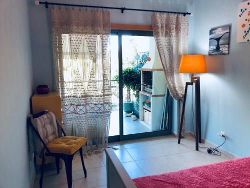 a bedroom with a bed and a lamp and a window at Pinetops holidays Apartment in Albufeira