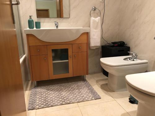 a bathroom with a sink and a toilet at Pinetops holidays Apartment in Albufeira