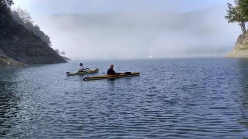 two people sitting in boats on a body of water at Amazing Lake View in Castel di Tora