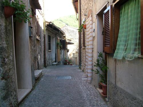 an alley with a stone road between two buildings at Amazing Lake View in Castel di Tora