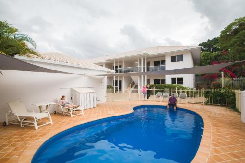 a family playing in the swimming pool of a house at Apartments on Palmer in Rockhampton