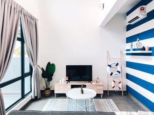 a living room with blue and white stripes on the wall at Kuantan Imperium by Glex in Kuantan