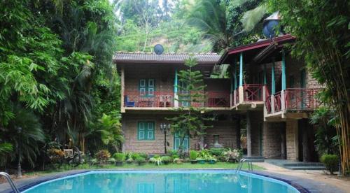 a house with a swimming pool in front of it at Hareesha Holiday Resort in Galle
