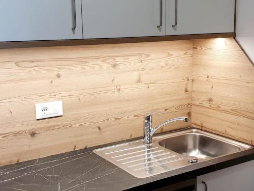 a kitchen with a sink and a counter top at Residence Majarai in Colfosco