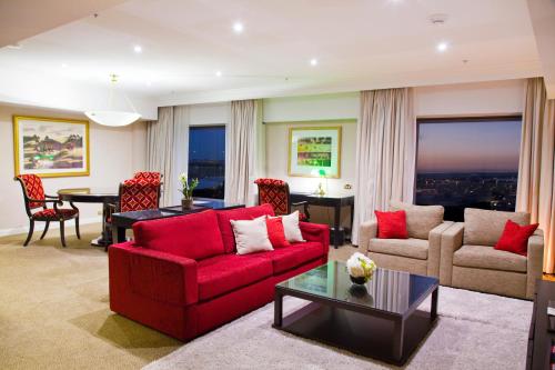 a living room filled with furniture and a couch at Stamford Plaza Sydney Airport Hotel & Conference Centre in Sydney